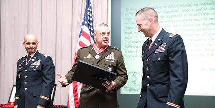 Maj. Gen. Michael Turley, the adjutant general of the Utah National Guard, accepts his silver de Fleury award from Col. Woodrow Miner, commander of the 204th Maneuver Enhancement Brigade and Lt. Col. Blake Bingham, commander of the 1457th Engineer Battalion in a ceremony at the Utah National Guard Headquarters May 22, 2021