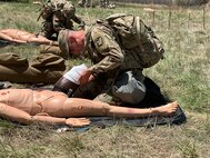 Soldier performs first-aid on dummy