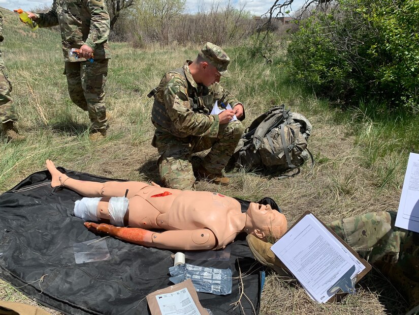 Soldier performs first-aid on dummy.