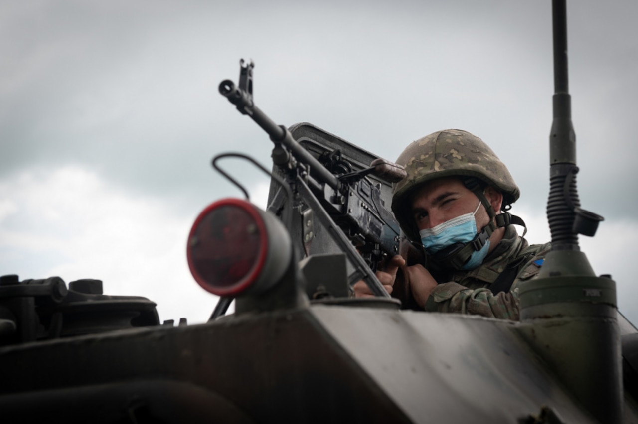 A Romanian soldier mounts his weapon in an exercise.