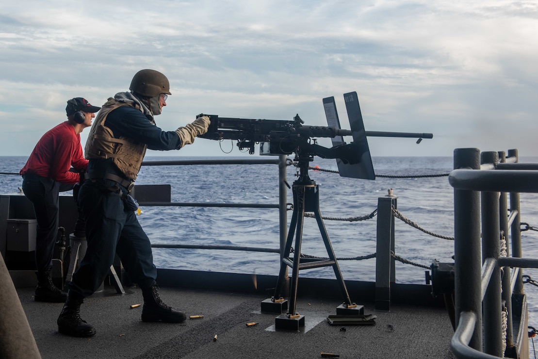 A Sailor fires a .50-caliber machine gun during a "Killer Tomato" live-fire exercise on the fantail of the U.S. Navy's only forward-deployed aircraft carrier USS Ronald Reagan (CVN 76).