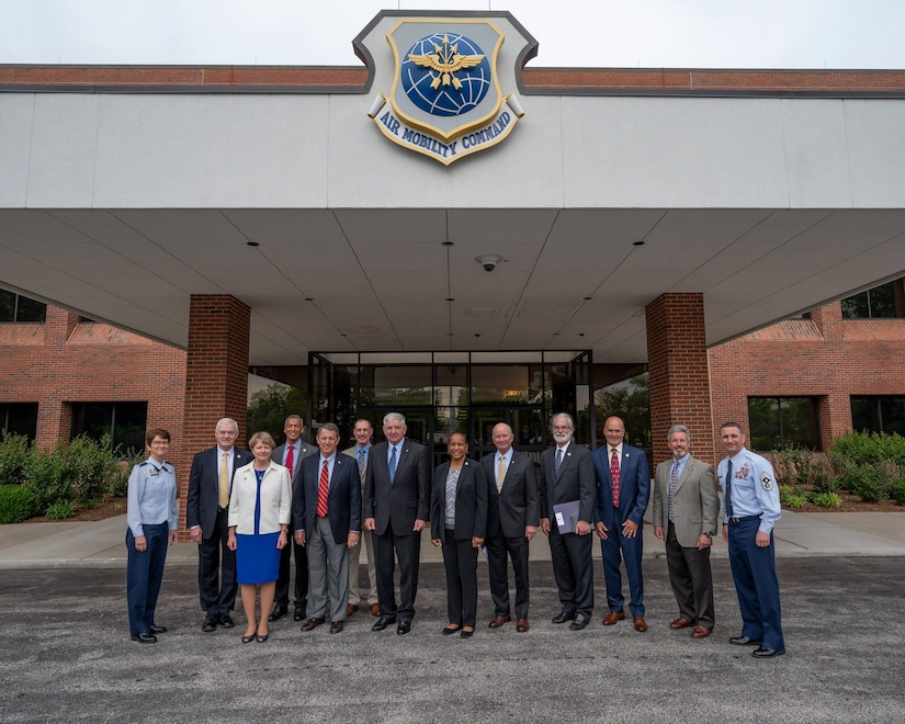 Gen. Jacqueline Van Ovost, Air Mobility Command commander, far left, and Chief Master Sgt. Brian Kruzelnick, AMC command chief, far right, gather with former AMC senior leaders at Scott Air Force Base, Illinois, May 27, 2021. For the first time, former commanders and command chiefs met to formally collaborate on efforts concerning the Mobility Air Forces during the Mobility Statesmen symposium.