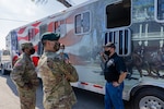 U.S. Army Sgt. 1st Class Timothy French, right, assigned to the U.S. Army North Caisson Platoon, describes the advantages of the caisson platoon’s new trailer to Lt. Col. Richard Teta, center, U.S. Army North battalion commander, and Capt. William Giddens, left, Headquarters Support Company, Headquarters and Headquarters Battalion, U.S. Army North commander, on Joint Base San Antonio - Fort Sam Houston, April 8, 2021.