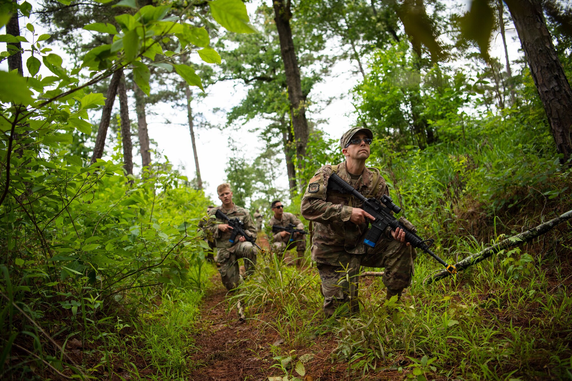 Airmen from the 2nd Civil Engineer Squadron perform individual movement techniques and unidentified explosive ordnance identification during a 2nd CES training exercise at Barksdale Air Force Base, Louisiana, May 20, 2021. Training operational skills such as land navigation, weapons assembly and individual movement techniques, the 2nd CES intensified the readiness of its engineers, allowing the unit to better adapt to changes in the national security environment and compete in the dynamic future of warfighting. (U.S. Air Force photo by Senior Airman Jacob B. Wrightsman)