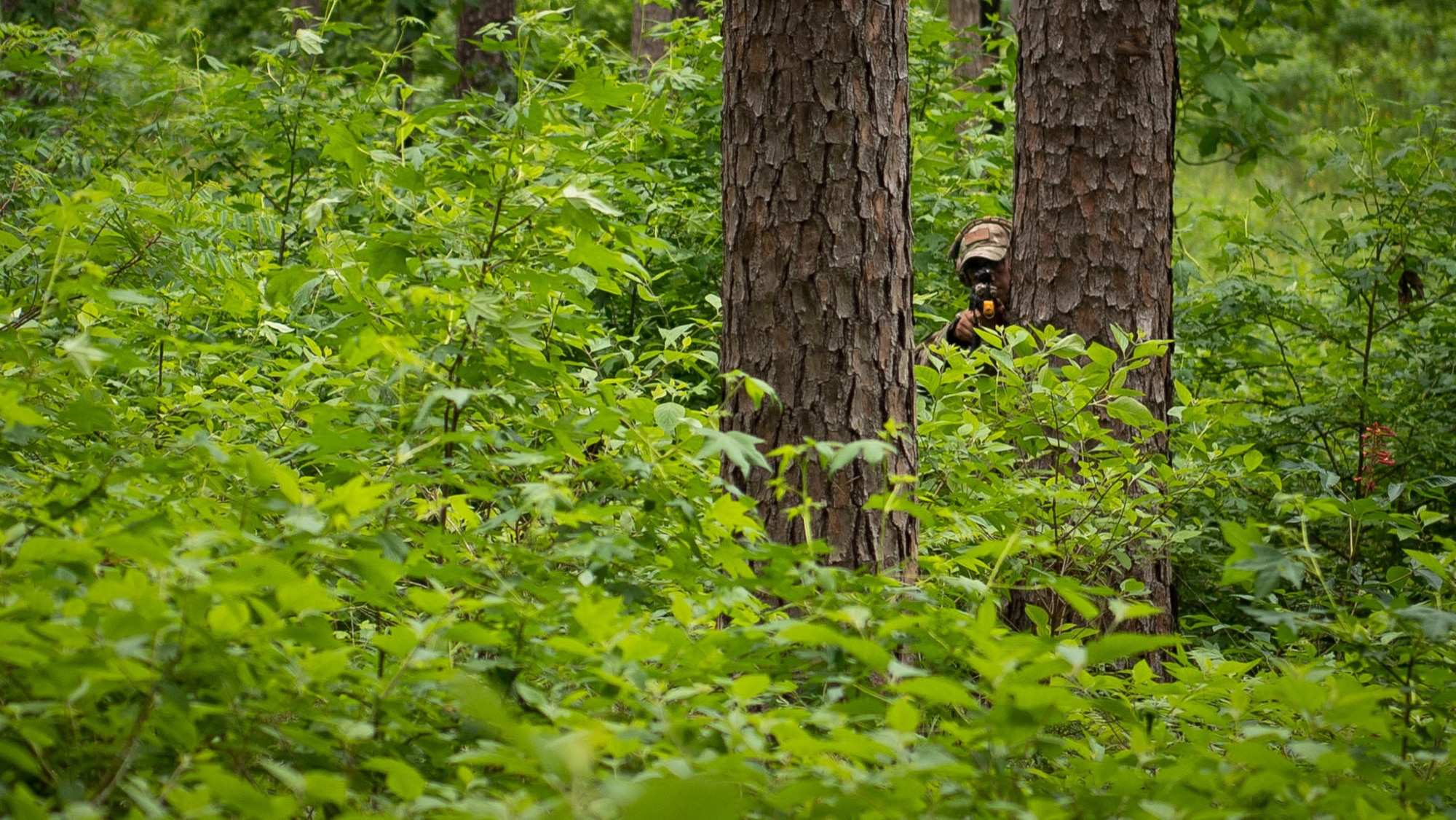 Master Sgt. Donald Manuel Jr., 2nd Civil Engineer Squadron explosive ordnance disposal craftsman, aims his M4 rifle during a 2nd CES training exercise at Barksdale Air Force Base, Louisiana, May 20. 2021. The exercise included various units across the 2nd CES and included skills such as land navigation, unidentified explosive ordnance identification and individual movement techniques. (U.S. Air Force photo by Senior Airman Jacob B. Wrightsman)