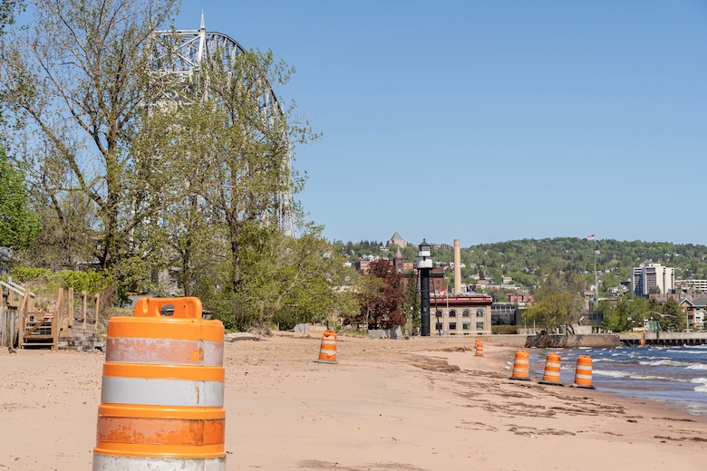U.S. Army Corps of Engineers, Duluth Area Office place construction barrels at places of known debris buried in the sand from 2020 beach nourishment operations in Duluth, Minn., May 28, 2021. The City of Duluth and Corps of Engineers have a plan to cleanup the beach.
