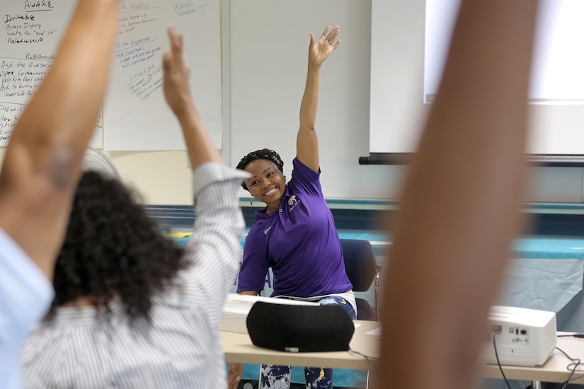 Maryam “Yama” Gidado leads a stretching exercise after a class instruction at the Stand for Life training event at Camp Bullis, Texas, May 11, 2021.