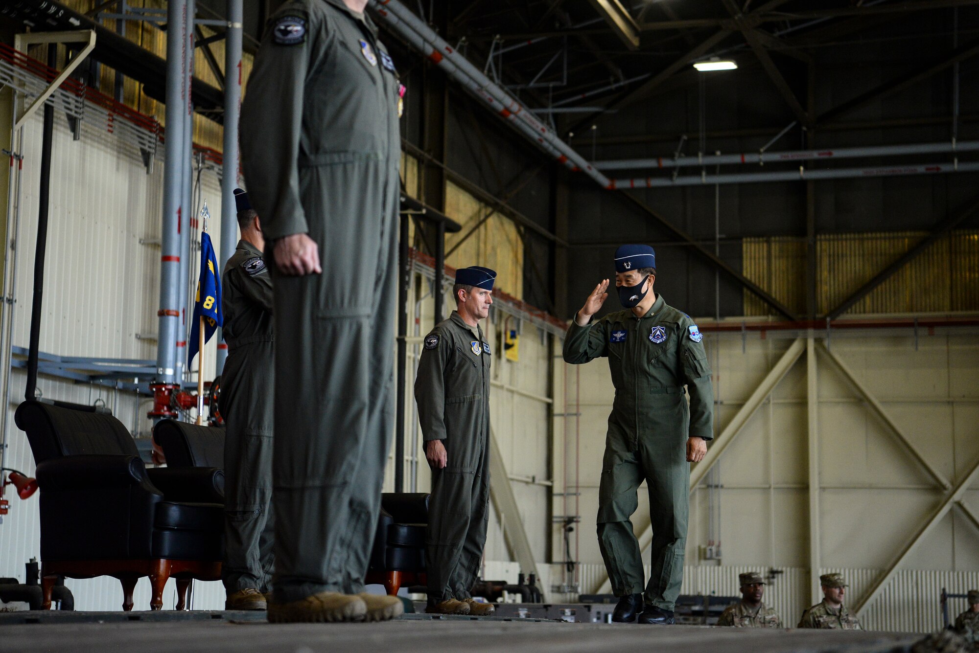 A commander salutes during a ceremony.