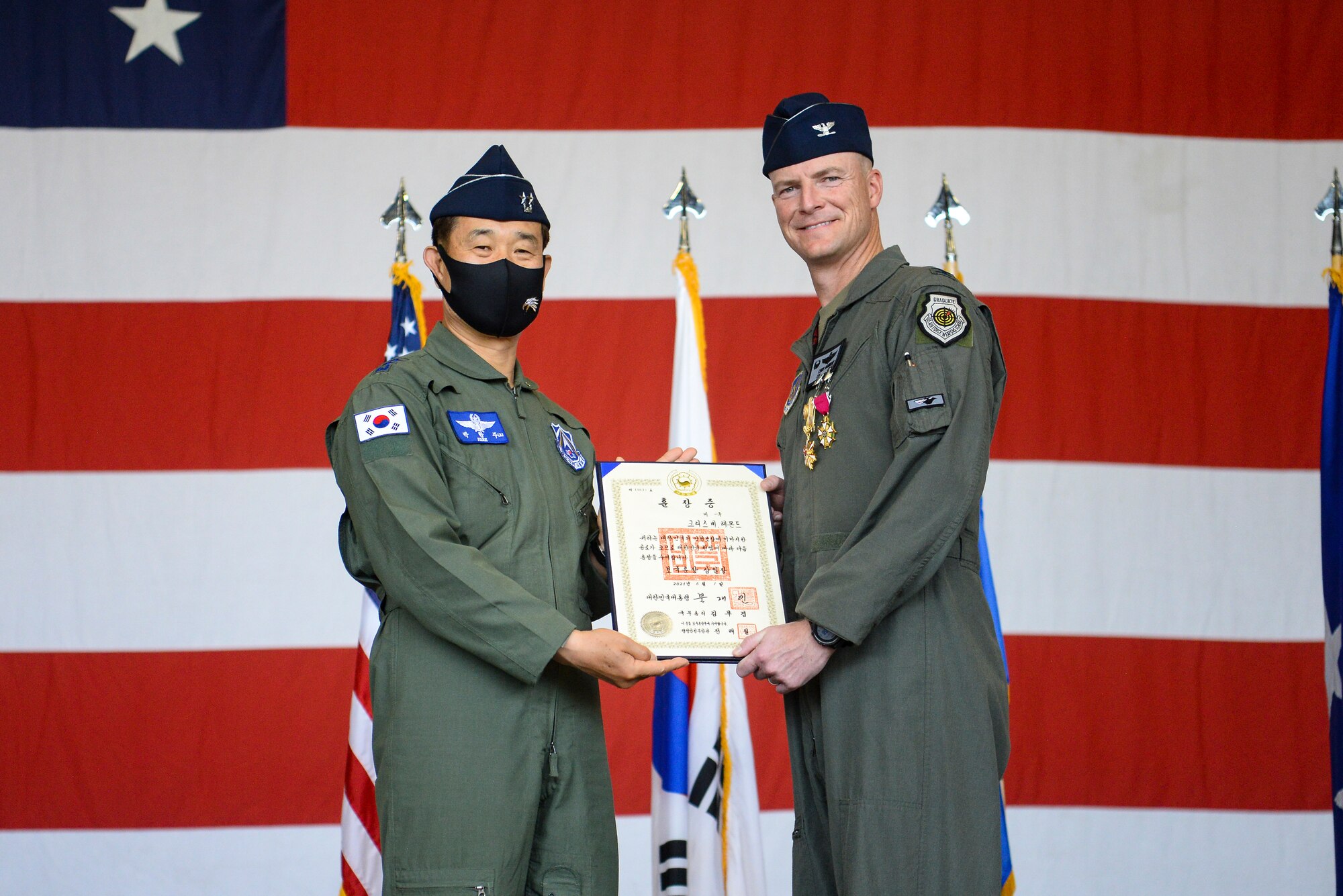 A commander receives a medal during a ceremony.