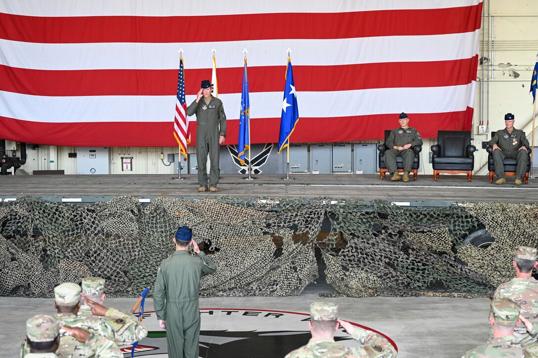 A commander salutes his command during a ceremony.
