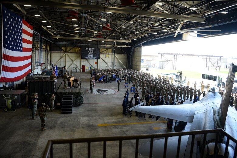 Airmen salute during a ceremony.