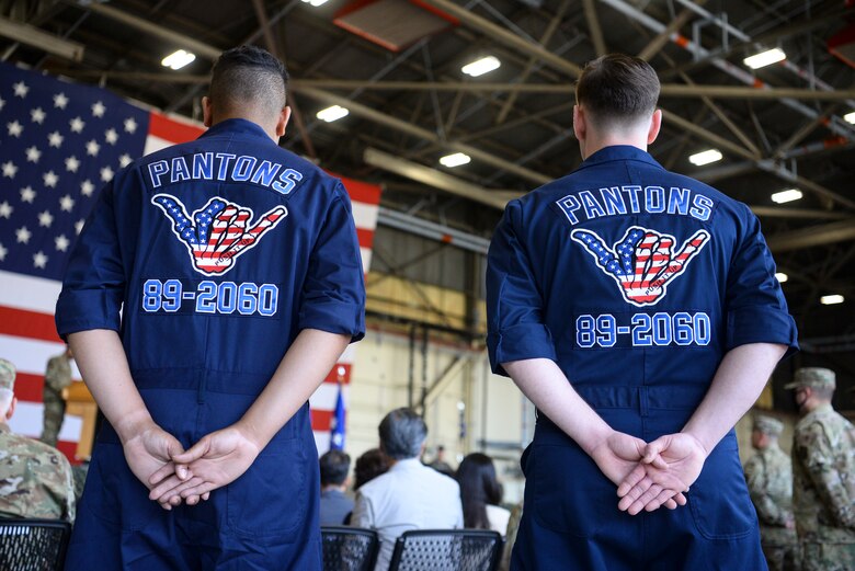 Airmen stand at parade rest during a ceremony.