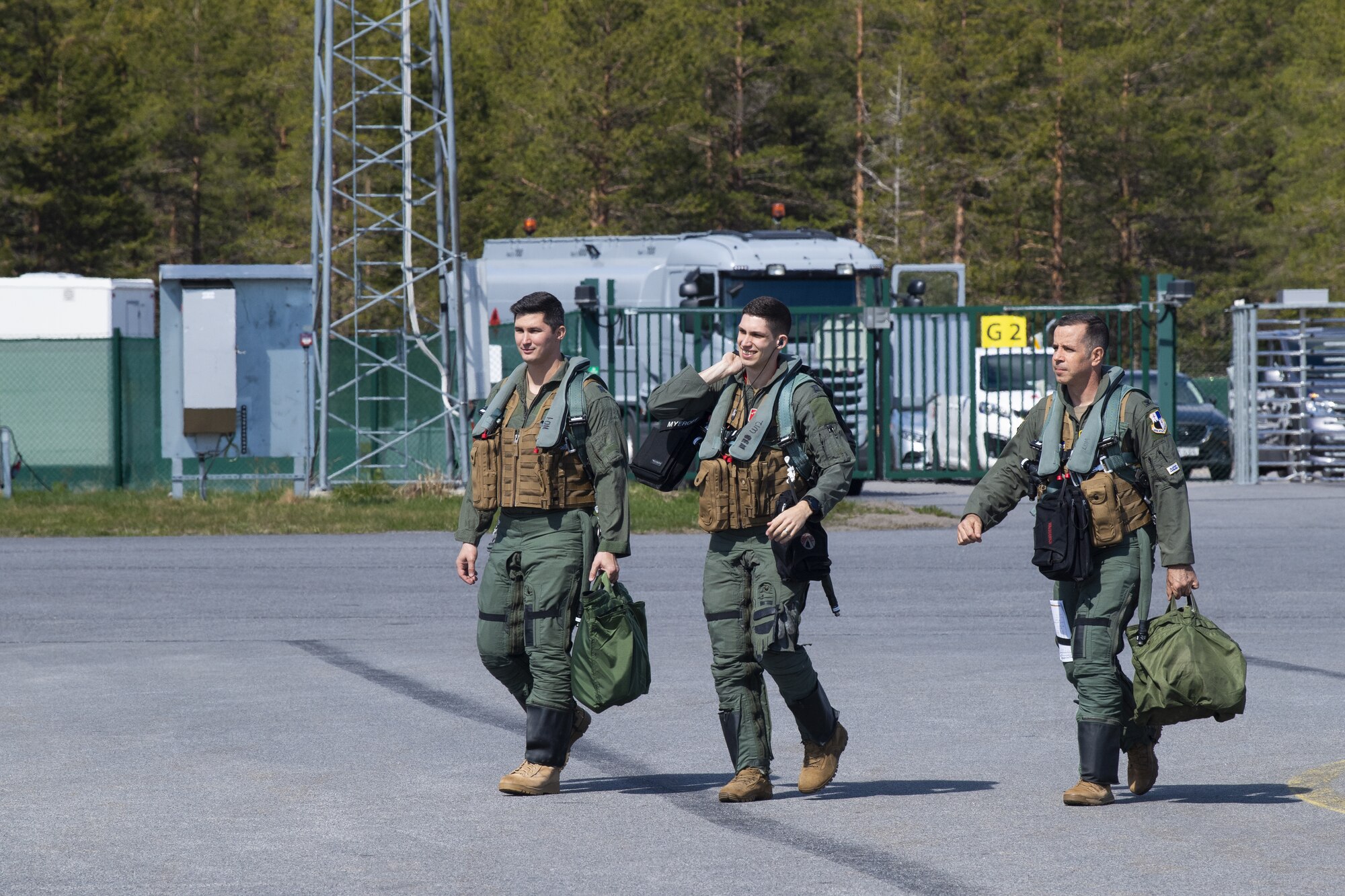 U.S. Air Force Airmen from the 480th Fighter Squadron at Spangdahlem Air Base, Germany, walk out to the F-16 Fighting Falcon aircraft at Kallax Air Base, Sweden, May 25, 2021. Airmen from across the 52nd Fighter Wing deployed to Sweden in support of the Arctic Challenge Exercise 2021, a multi-national exercise dedicated to improving interoperability between allied nations. (U.S. Air Force photo by Senior Airman Ali Stewart)