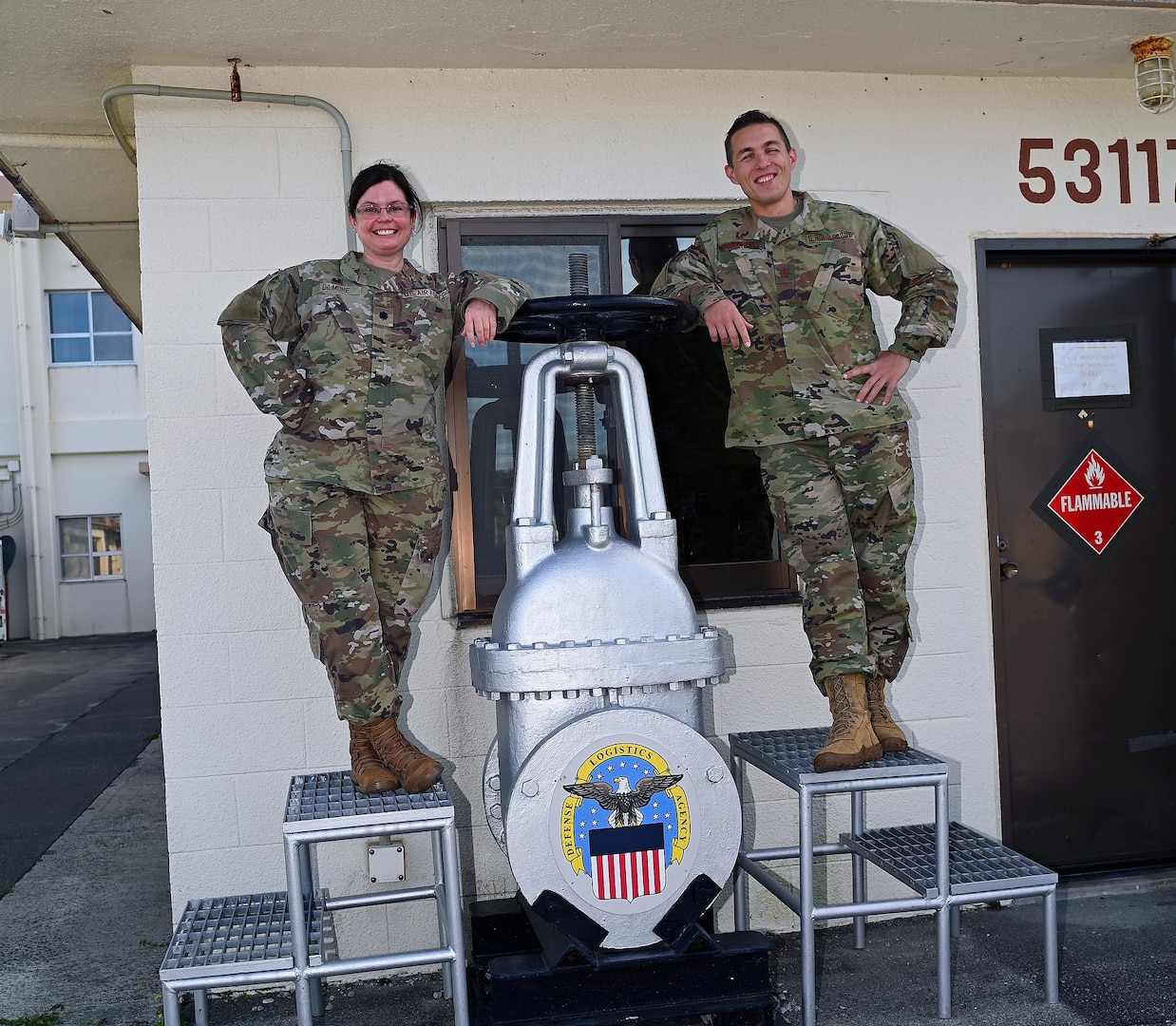 two air force officers pose in uniform