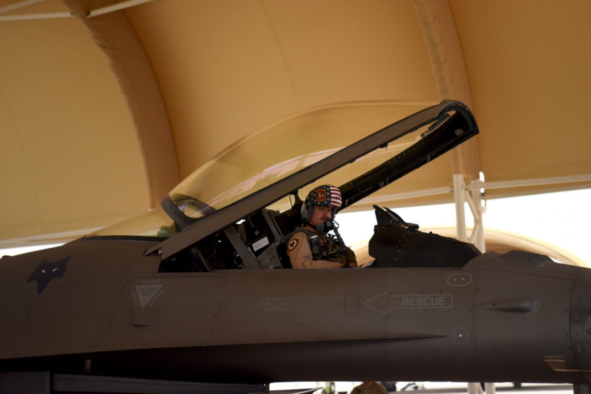 Maj. Shaun Hoeltje, 157th Expeditionary Fighter Squadron pilot, prepares for a flight aboard an F-16 Fighting Falcon fighter jet at Prince Sultan Air Base, Kingdom of Saudi Arabia, May 16, 2021. The "Swamp Fox" airmen from the South Carolina Air National Guard are deployed to PSAB to project combat power and help bolster defensive capabilities against potential threats in the region. (U.S. Air National Guard photo by Senior Master Sgt. Carl Clegg, 169th Fighter Wing Public Affairs)