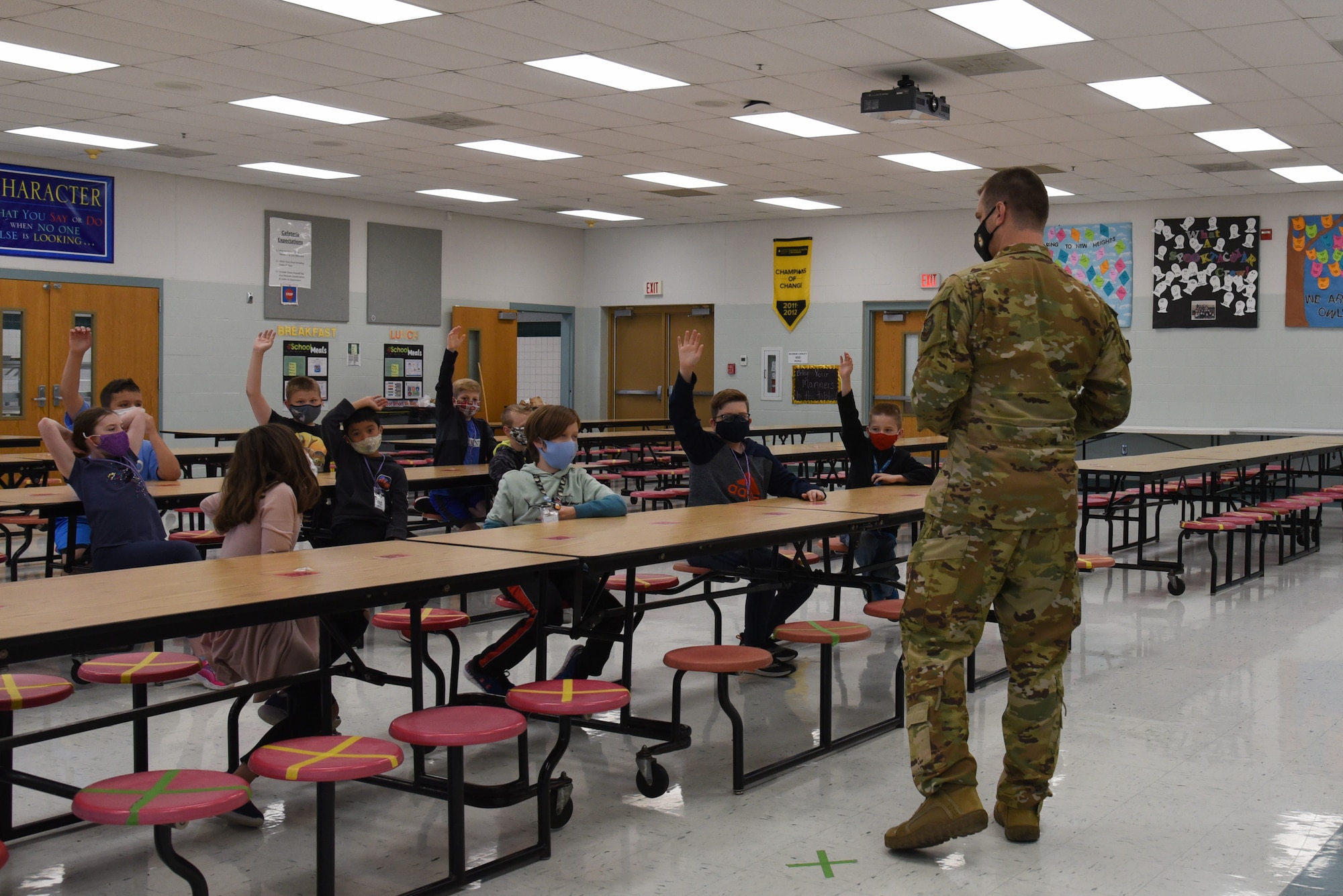U.S. Air Force Capt. Adam Peck, 375th Air Mobility Wing chaplain, reads to students at Scott Elementary School on Scott Air Force Base, Illinois May 12, 2021. Peck shared stories from his ancestors who lived in Mossy Creek, Tennessee, to give the students a better understanding of history. (U.S. Air Force photo by Airman 1st Class Mark Sulaica)