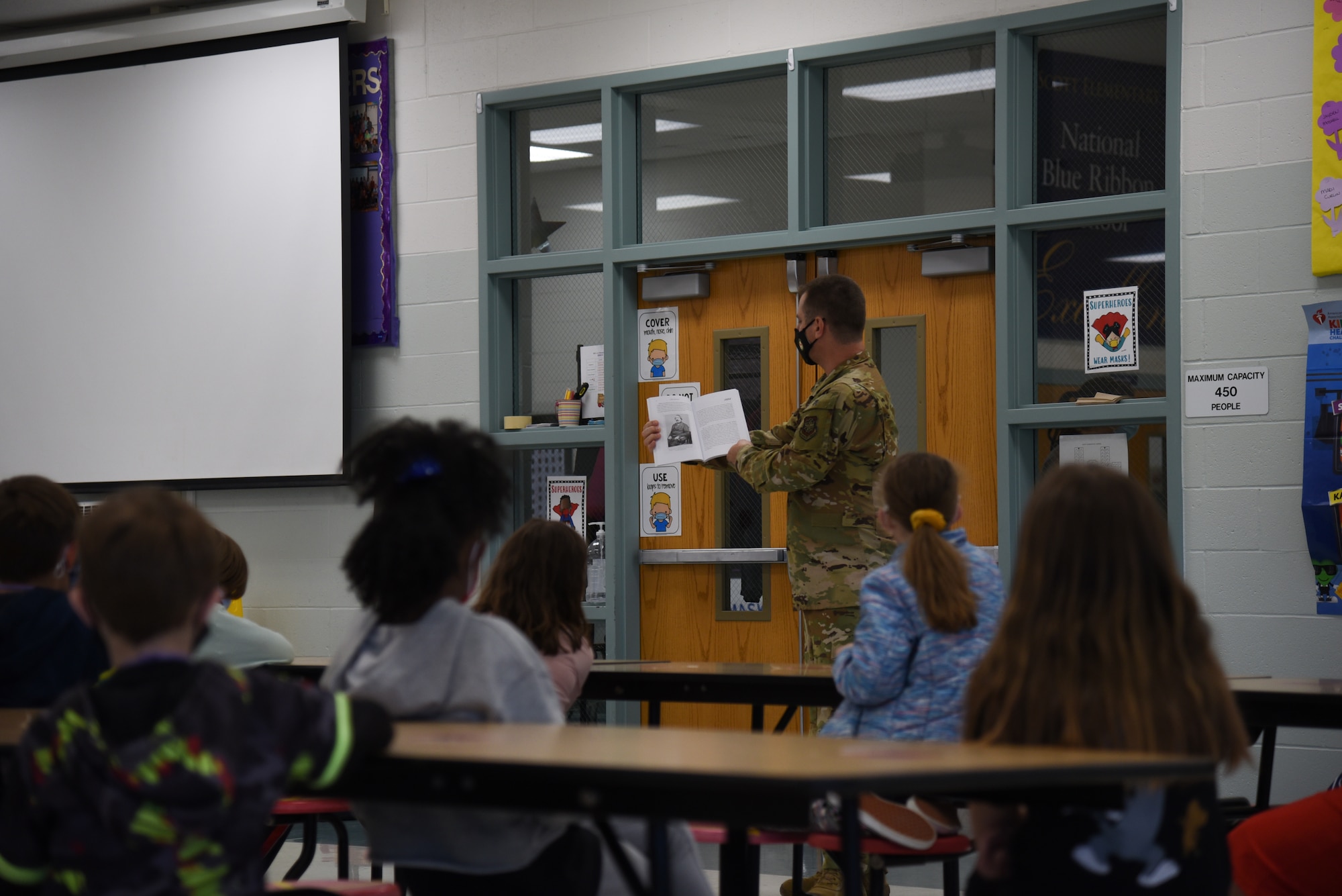 U.S. Air Force Capt. Adam Peck, 375th Air Mobility Wing chaplain, shares his ancestor’s experiences at Scott Elementary School on Scott Air Force Base, Illinois, May 12, 2021.  Peck was given the opportunity to read stories of his ancestor’s to the students, providing a glimpse into a lifestyle of the past. (U.S. Air Force photo by Airman 1st Class Mark Sulaica)