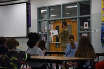 U.S. Air Force Capt. Adam Peck, 375th Air Mobility Wing chaplain, shares his ancestor’s experiences at Scott Elementary School on Scott Air Force Base, Illinois, May 12, 2021.  Peck was given the opportunity to read stories of his ancestor’s to the students, providing a glimpse into a lifestyle of the past. (U.S. Air Force photo by Airman 1st Class Mark Sulaica)