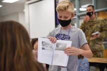 A student at Scott Elementary School shows images of his family’s history to classmates on Scott Air Force Base, Illinois, May 12, 2021. Capt. Adam Peck 375th Air Mobility Wing chaplain, read to students at Scott Elementary School, and showed the images containing information about Peck’s family history from the 1850's.  (U.S. Air Force photo by Airman 1st Class Mark Sulaica)