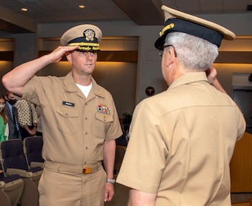 Gerald Delong salutes Capt. Adam Armstrong, as he assumes command.