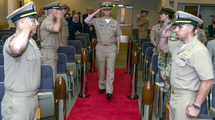 Navy Capt. Gerald DeLong, incoming commander for Naval Medical Research Unit-San Antonio, is saluted by the sideboys