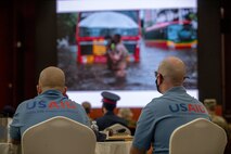 210525-N-KZ419-1026 MANAMA, Bahrain (May 25, 2021) U.S. Agency for International Development (USAID) Humanitarian Assistance Advisers, Adam Tousley, left, and Chris Williams, watch a presentation about natural disasters during a Humanitarian Operations Workshop hosted by the Bahrain Ministry of Interior, and facilitated by U.S. Naval Forces Central Command (NAVCENT) and USAID in Manama, Bahrain, May 25.  NAVCENT is the U.S. Navy element of U.S. Central Command in the U.S. 5th Fleet area of operations and encompasses about 2.5 million square miles of water area that includes the Arabian Gulf, Gulf of Oman, Red Sea and parts of the Indian Ocean. (U.S. Navy photo by Mass Communication Specialist 3rd Class Dawson Roth)