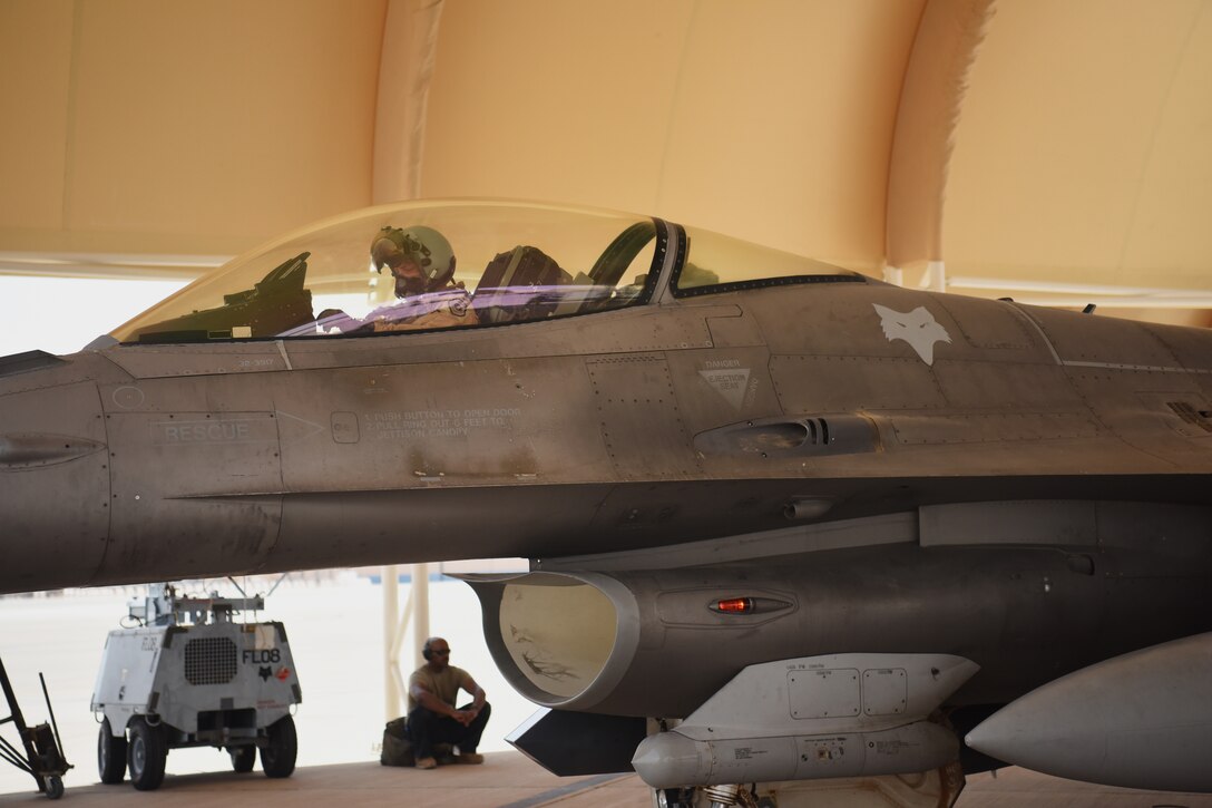 Col. Kristoffer Smith, 378th Expeditionary Operations Group commander, prepares for a flight aboard an F-16 Fighting Falcon fighter jet for takeoff at Prince Sultan Air Base, Kingdom of Saudi Arabia, May 16, 2021. The "Swamp Fox" airmen from the South Carolina Air National Guard are deployed to PSAB to project combat power and help bolster defensive capabilities against potential threats in the region. (U.S. Air National Guard photo by Senior Master Sgt. Carl Clegg, 169th Fighter Wing Public Affairs)