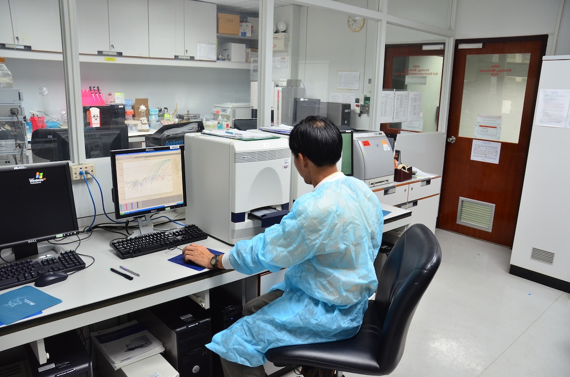 AFRIMS Virology scientist examines data generated on a computer.