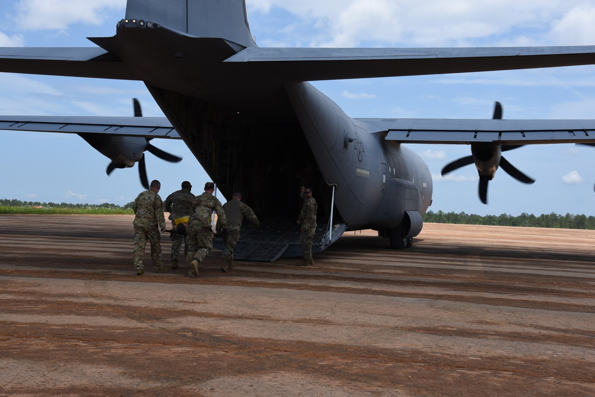 The 815th Airlift Squadron trained with aeromedical evacuation personnel completing engine running on and off load of patients during Voyager Shield, an exercise hosted by the 621st Air Mobility Advisory Group at the Joint Readiness Training Center and Fort Polk, La., May 25-27. This exercise provided the 815th AS required tactical training for the pilots and loadmasters, while they provided airlift and airdrop support. Pilots trained on communicating with landing and drop zone controllers, semi-prepared runway operations, and assault landings. Loadmaster specific training included rolling stock loading/unloading in both normal and engine running operations, patient loading with engines running and personnel drops. (U.S. Air Force photo by Jessica L. Kendziorek)