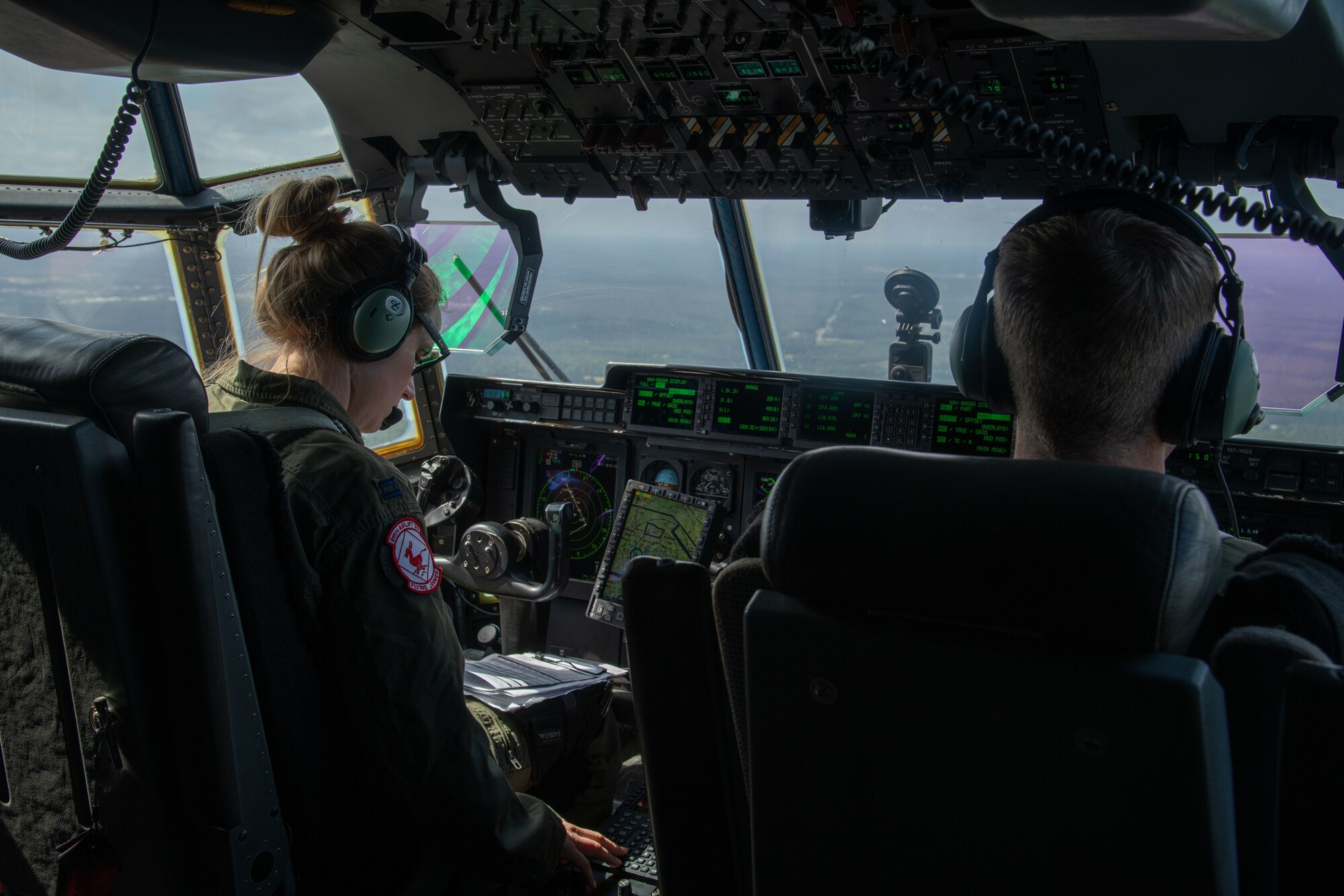 Capt. Leesa Froelich, aircraft commander, and Capt. Montgomery Sloat, co-pilot, both of the 815th Airlift Squadron “Flying Jennies” at Keesler Air Force Base, Miss., prepare to land at the Joint Readiness Training Center and Fort Polk, La., May 25, 2021. The 815th AS provided airlift and airdrop support during Voyager Shield, an exercise hosted by the 621st Air Mobility Advisory Group, May 25-27, while the Flying Jennies received required tactical training for pilots and loadmasters. (U.S. Air Force by Staff Sgt. Kristen Pittman)