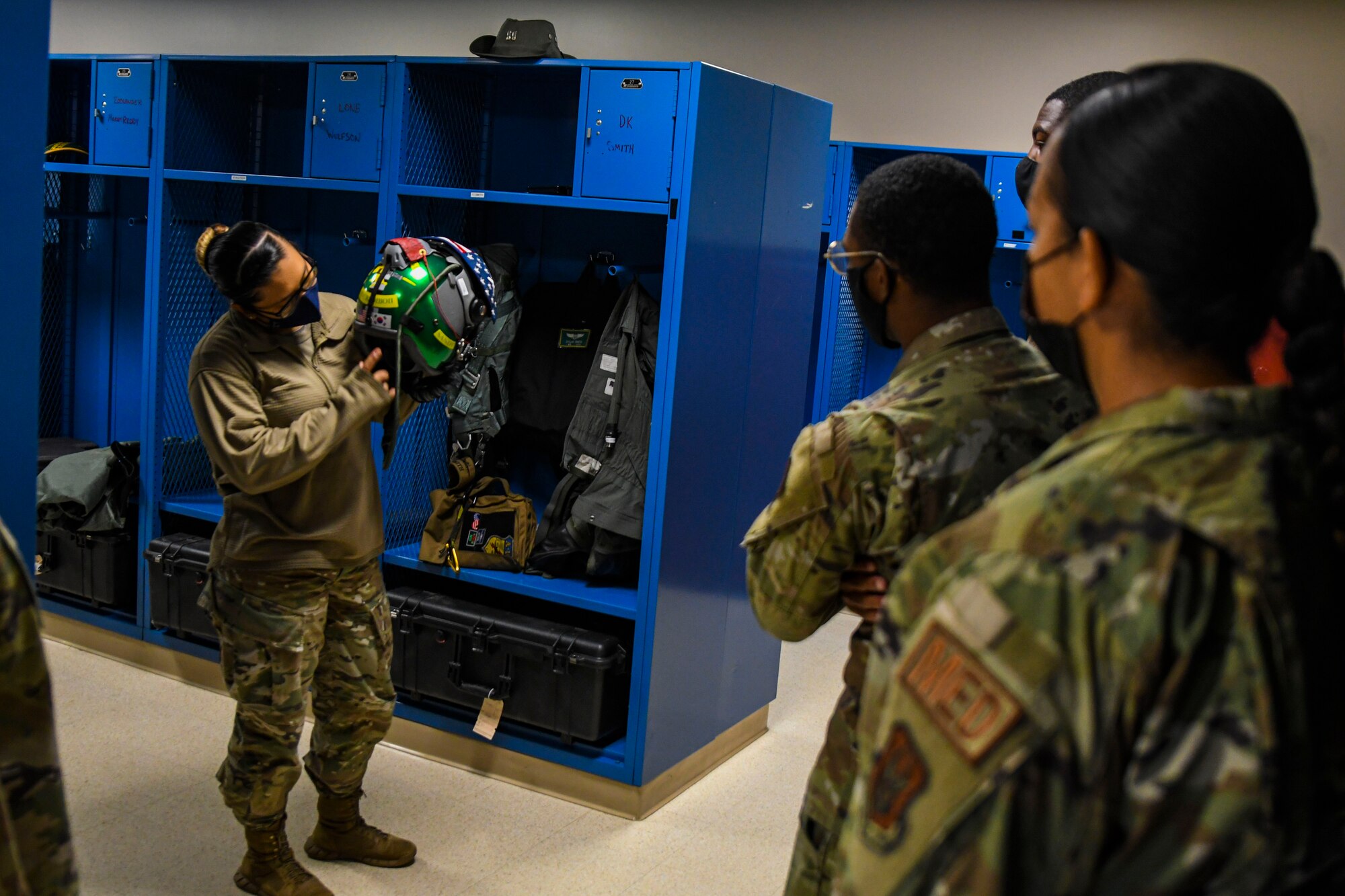 A photo of an airmen holding a pilot's helmet