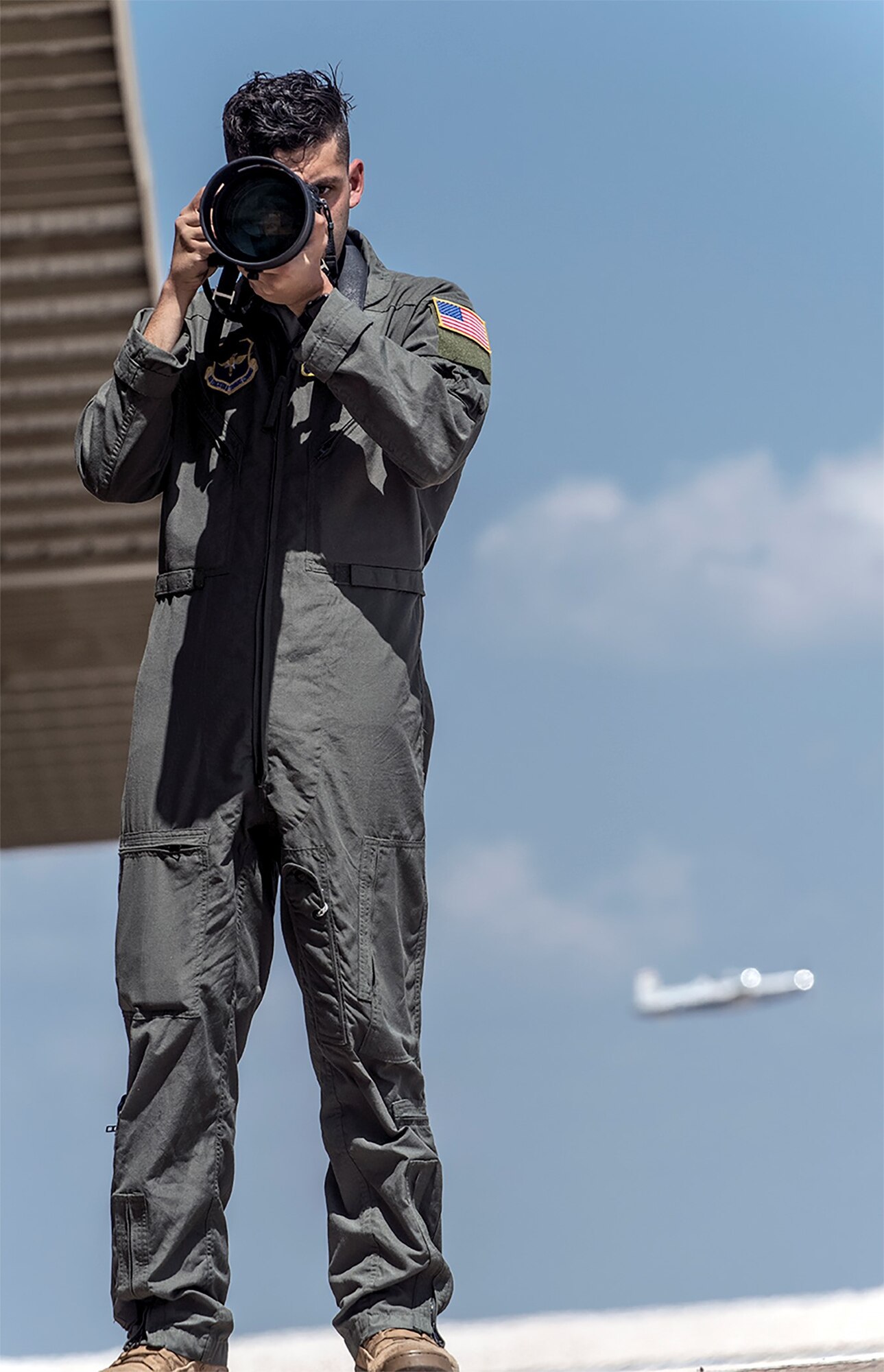 Airman 1st Class David Phaff poses for a photo on the flight line on Mar. 24, 2021, at Laughlin Air Force base, Texas. This airman is a aerial photographer who specializes capturing content while flying in aircraft. (U.S. Air Force photo by Master Sgt. JT May III)