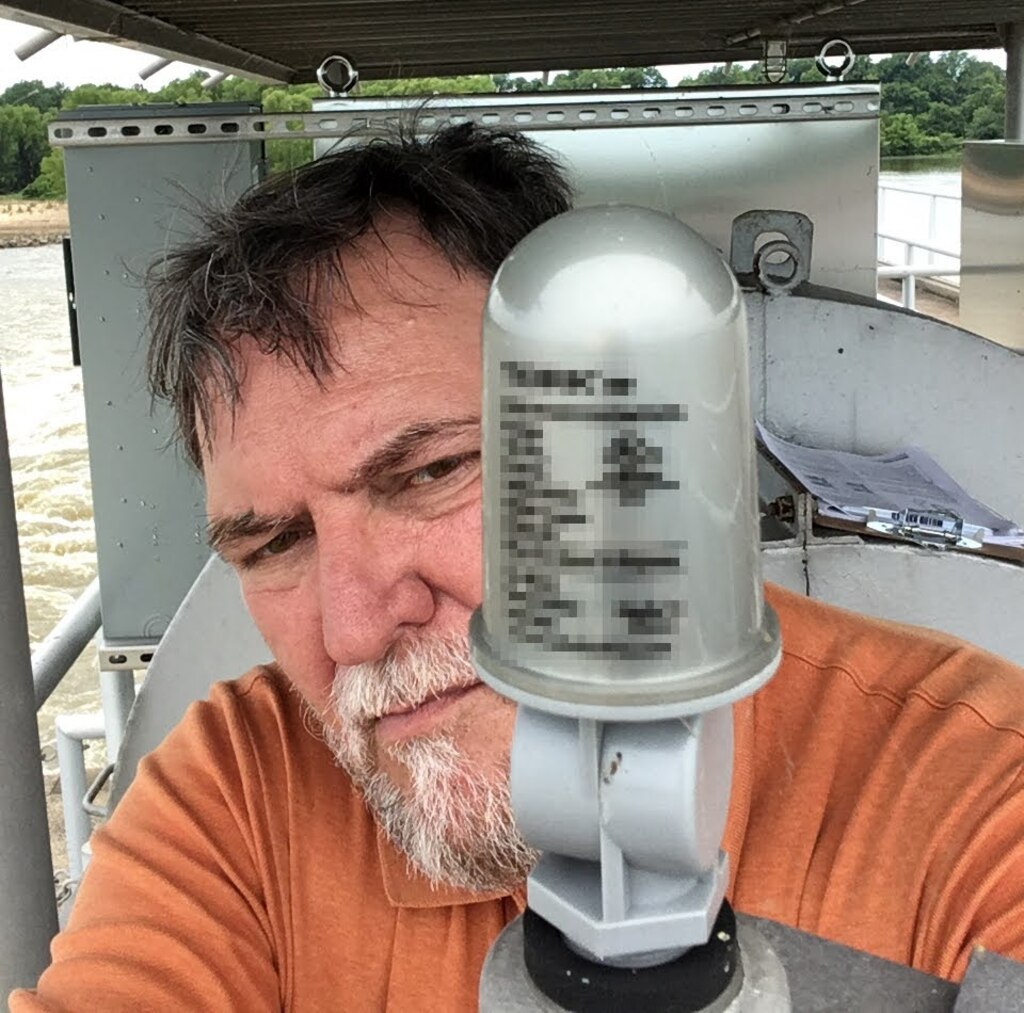 Man standing behind an electronic instrument