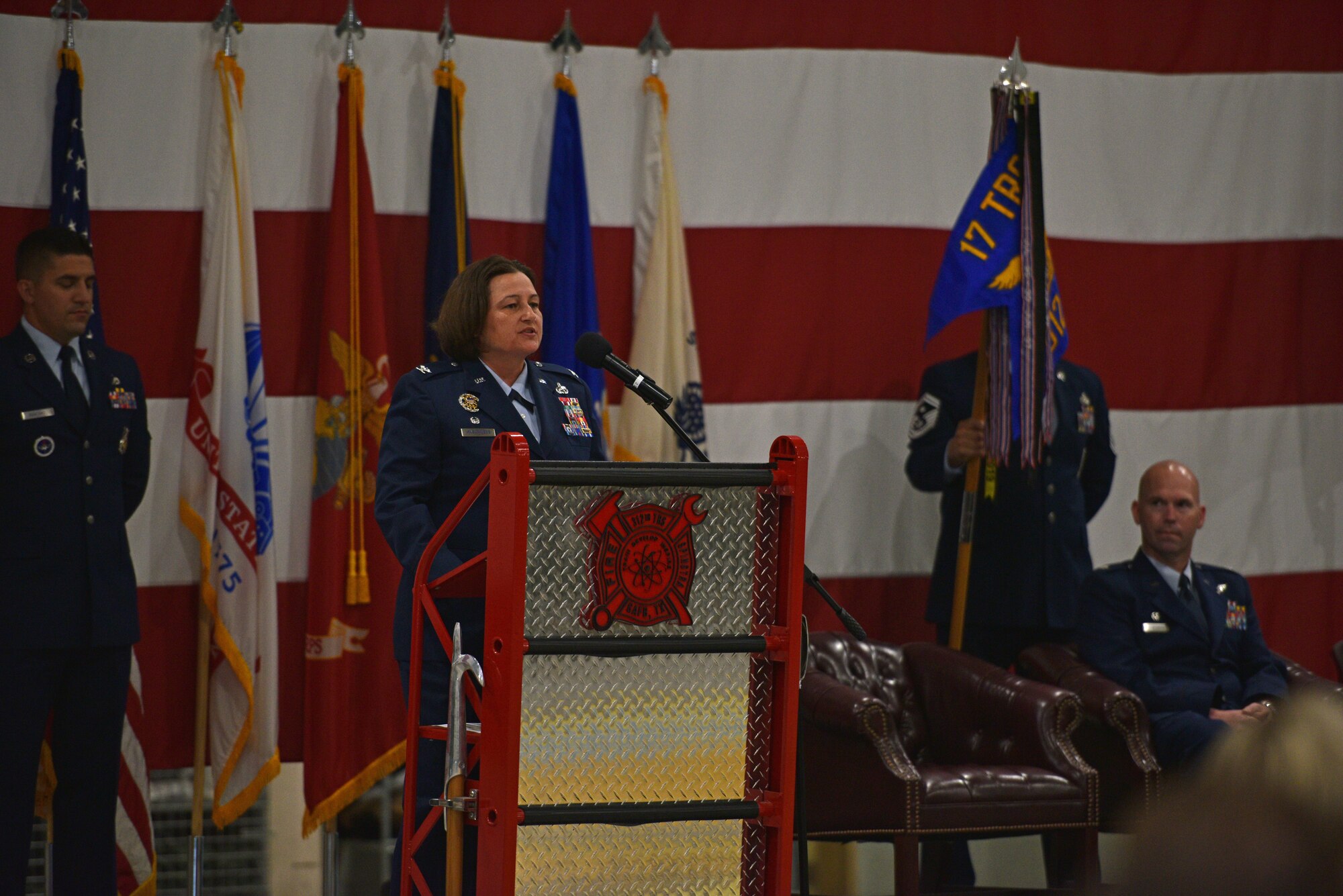 U.S. Air Force Col. Angelina Maguinness, 17th Training Group commander, addresses the audience during the change of command ceremony at the Louis F. Garland Department of Defense Fire Academy High Bay on Goodfellow Air Force Base, Texas, June 1, 2021. Maguinness welcomed the 312th Training Squadron incoming commander, Maj. Samuel Logan, and thanked the 312th TRS outgoing commander, Lt. Col. Kevin Boss, for his hard work and dedication. (U.S. Air Force photo by Senior Airman Ashley Thrash)