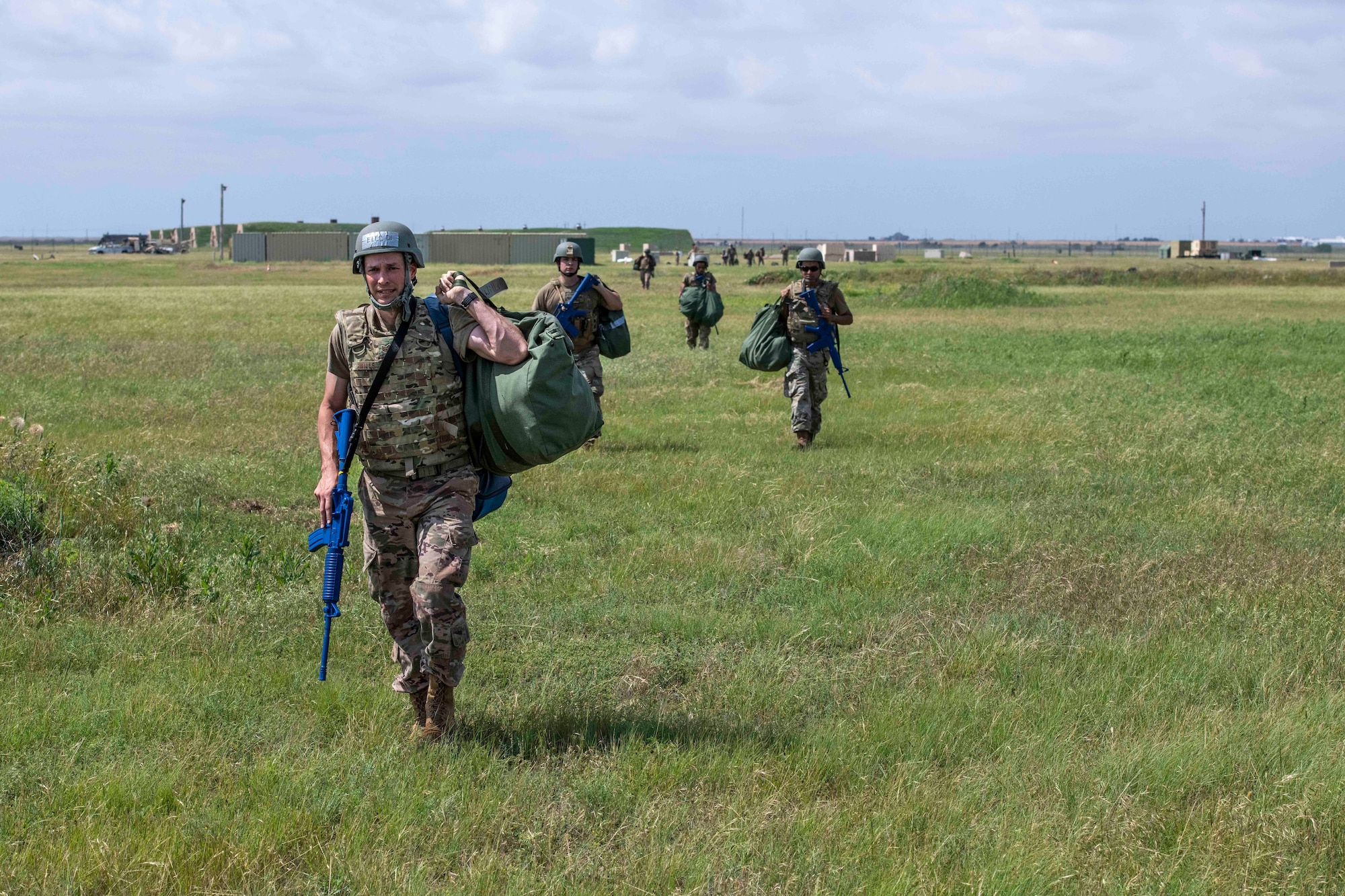 people walk with gear