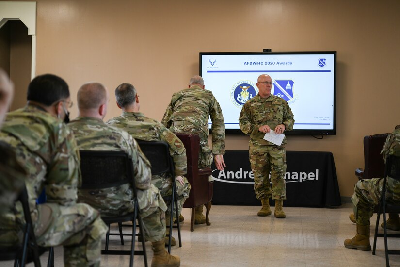 Col. Glenn Page, Air Force District of Washington command chaplain, introduces Maj. Gen. Steven A. Schaick, chief of chaplains, and Chief Master Sgt. Natalie Gray, U.S. Air Force religious affairs senior enlisted advisor, to the front of the room for an Annual Awards Presentation, at Chapel 1, Joint Base Andrews, Md., May 18, 2021. Typically, the Chief of Chaoplains and religious affairs senior enlisted advisor present the Air Force-level awards. (U.S. Air Force photo by Airman 1st Class Bridgitte Taylor)