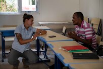 U.S. Army Sgt. Wilnelia Moralez, a medic with Civil Affairs East Africa (CA-EA), a forward deployed element of Southern European Task Force - Africa (SETAF-AF) and Combined Joint Task Force – Horn of Africa (CJTF-HOA), speaks to a student about her experience learning English as a second language during an English discussion group at Sunny Hill Hospitality School, Arta, May 20, 2021. The discussion groups aren’t purely about education; it is also a chance for military members and Djiboutian locals to learn about each other on a personal level by sharing similarities and differences.