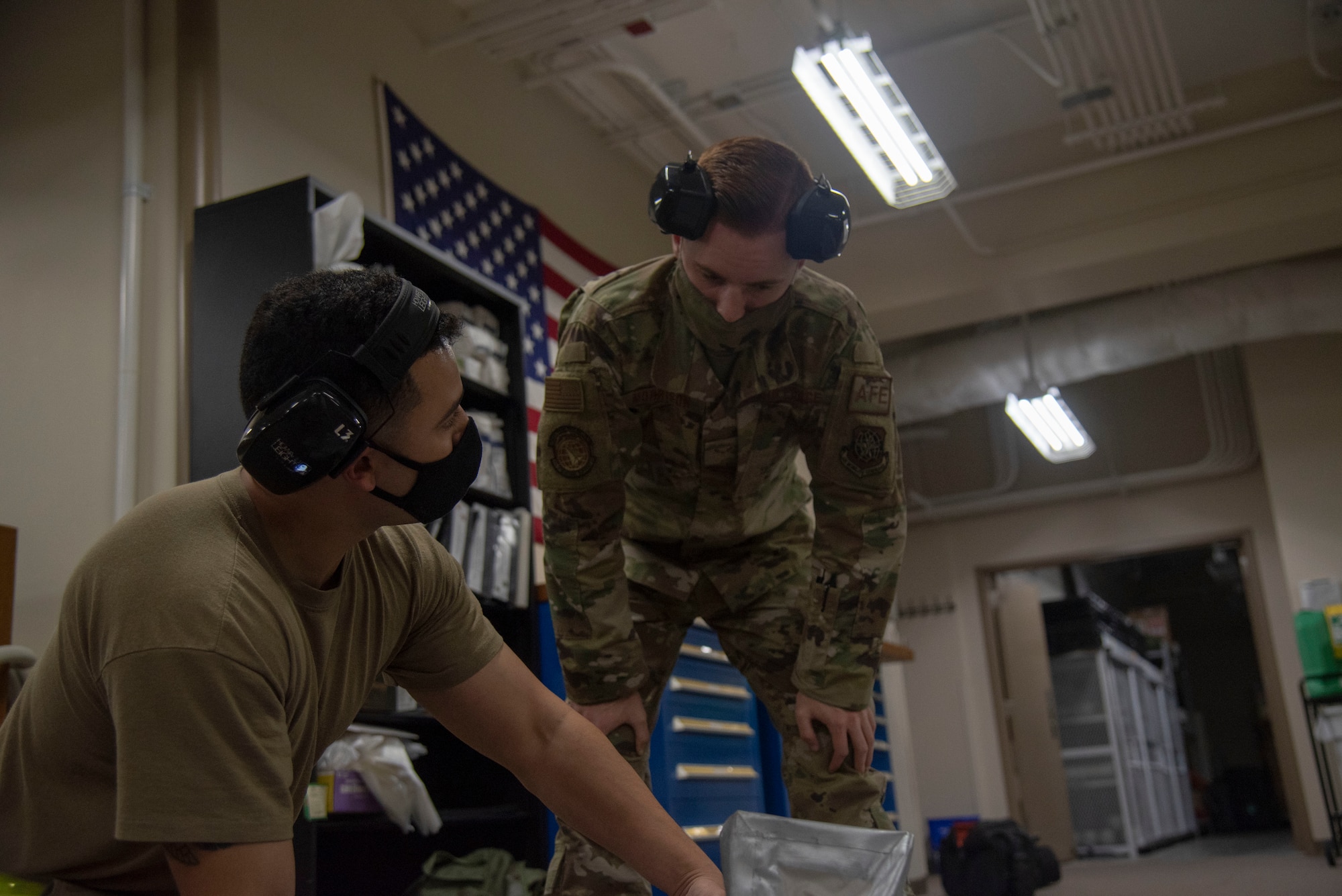 U.S. Air Force Staff Sgt. Gavin Weidel, 6th Operations Support Squadron (OSS) Aircrew Flight Equipment (AFE) Technician, instructs Airman 1st Class Daunte Morrison, 6th OSS AFE journeyman on emergency escape slide inspection procedures at MacDill Air Force Base, Florida, April 14, 2021. 6th OSS AFE members must be fully trained on lifesaving equipment and survival components as well as keep air crews trained and proficient on the use of such equipment.