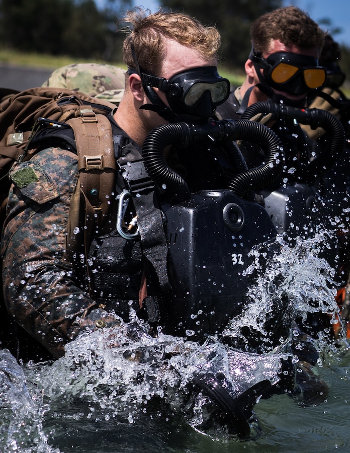 U.S. Marines with a Force Reconnaissance Platoon (FRP), 31st Marine Expeditionary Unit (MEU), enter the water at Kin Blue, Okinawa, Japan, May 20, 2021. The FRP regularly conducts dive operations to maintain proficiency as combat divers. The 31st MEU, the Marine Corps’ only continuously forward-deployed MEU, provides a flexible and lethal force ready to perform a wide range of military operations as the premier crisis response force in the Indo-Pacific region. (Lance Cpl. Joseph E. DeMarcus)