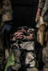 U.S. Marines with the Maritime Raid Force (MRF), 31st Marine Expeditionary Unit (MEU), carry a simulated adversary on Camp Hansen, Okinawa, Japan, May 18, 2021.