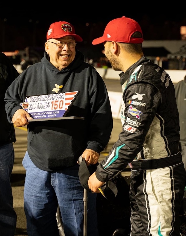 Michael Wieger Sr., father of Fallen Offiice of Special Investigations Special Agent Staff Sgt. David Wieger, accepts the race trophy from winning driver Justin Bonsignore in Victory Lane, following the Jennerstown Salutes 150 NASCAR Whelen Modified Tour race May 29, 2021, in Jennerstown, Pa. The Memorial Day weekend event honored the lives and legacies of military members past and present. (Photo by Zack Aubrey)