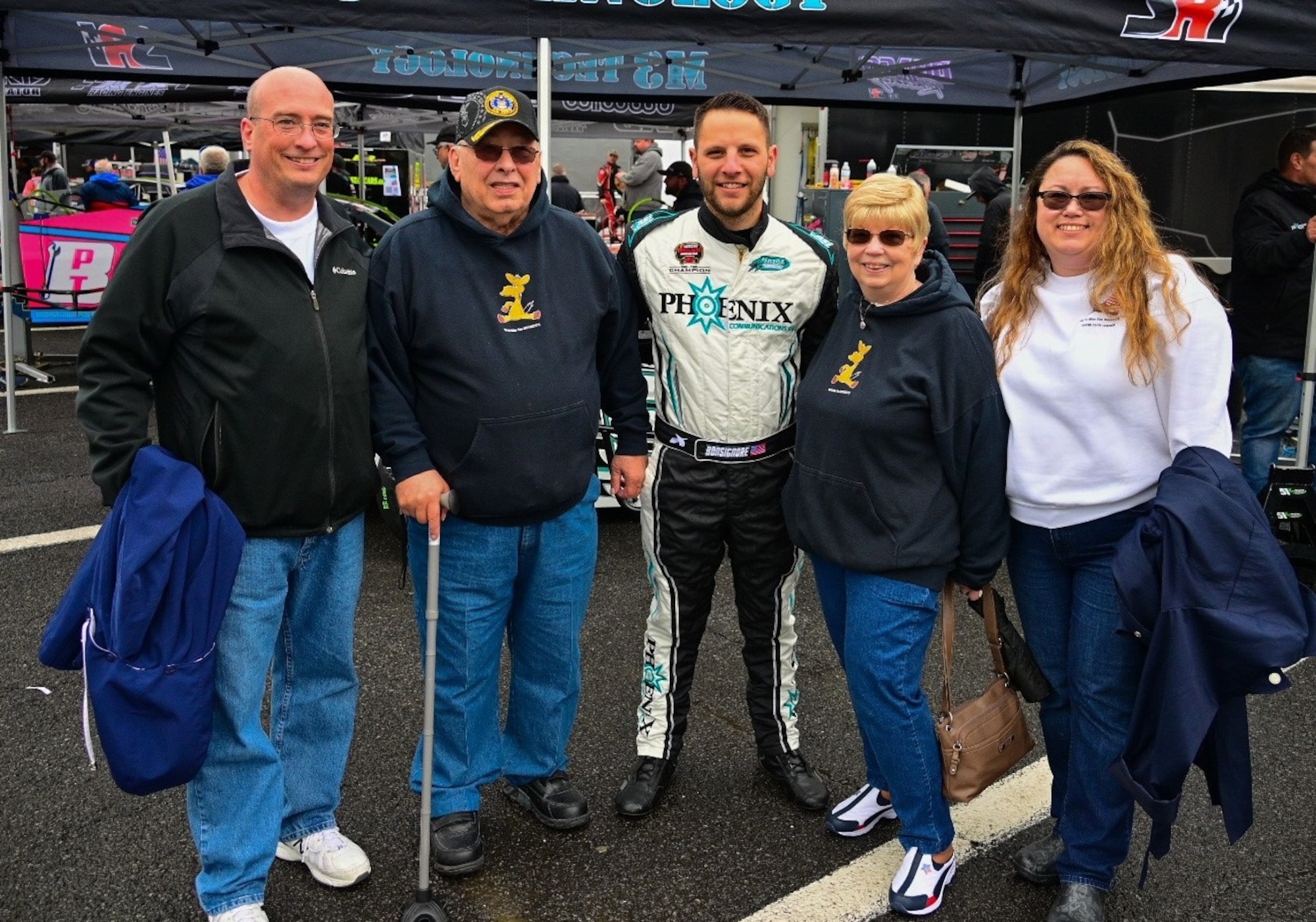 Two-time NASCAR Whelen Modified Tour Champion driver Justin Bonsignore joins the Gold Star Family of Fallen Office of Special Investigations Special Agent (Staff Sgt.) David Wieger, at Jennerstown Speedway prior to the Jennerstown Salutes 150 race honoring military members past and present, and their families, Memorial Day weekend May 29, 2021. (Left to right, brother Michael Wieger, Jr., father Michael Wieger Sr., mother Loreena Wieger and daughter-in-law Brenda Wieger) (Photo by Zack Aubrey)