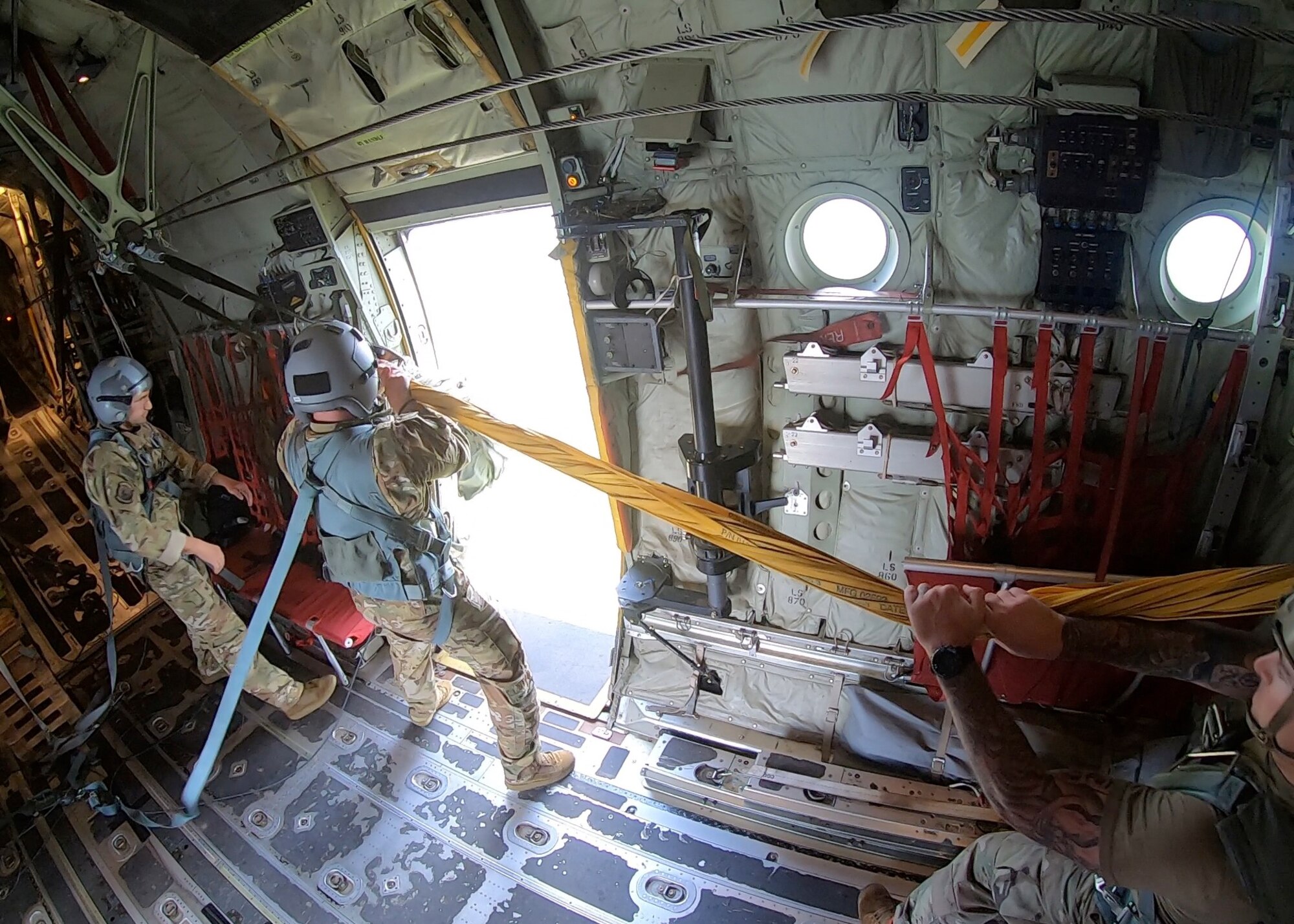 Airman 1st Class Mitchell Harvey, 815th Airlift Squadron loadmaster, pulls the parachute static line and bags into the C-130J Super Hercules after the Airborne parachutists' jump during Voyager Shield, an exercise hosted by the 621st Air Mobility Advisory Group at the Joint Readiness Training Center and Fort Polk, La., May 25-27. This exercise provided the 815th AS required tactical training for the pilots and loadmasters, while they provided airlift and airdrop support. Pilots trained on communicating with landing and drop zone controllers, semi-prepared runway operations, and assault landings. Loadmaster specific training included rolling stock loading/unloading in both normal and engine running operations, patient loading with engines running and personnel drops. (U.S. Air Force photo by Jessica L. Kendziorek)