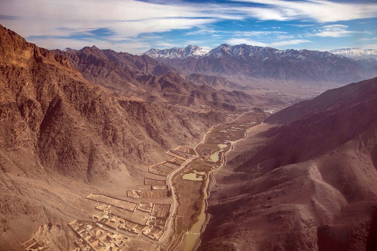 Housing, walls and other structures are nestled in a valley.