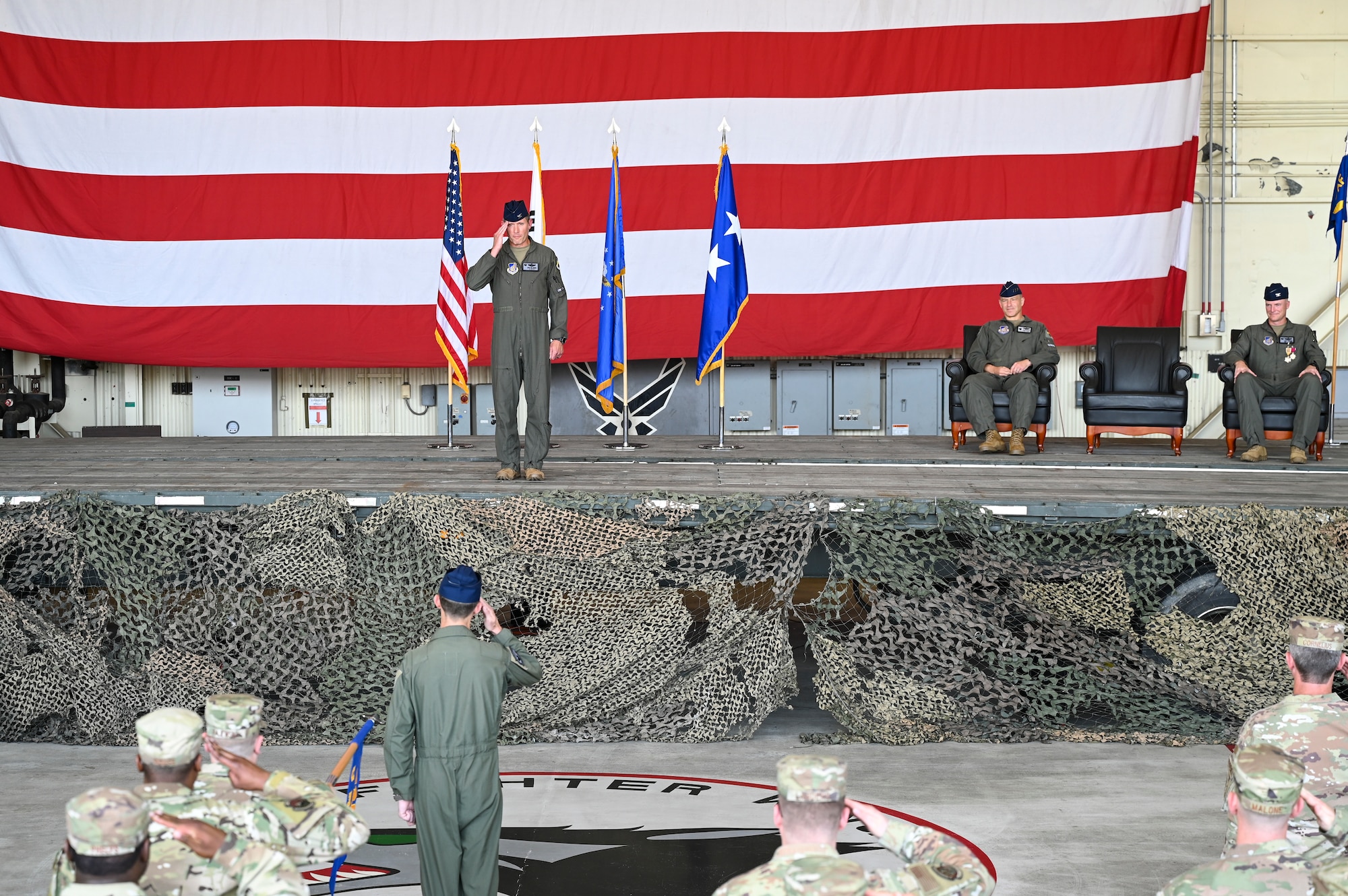 A commander salutes his command during a ceremony.