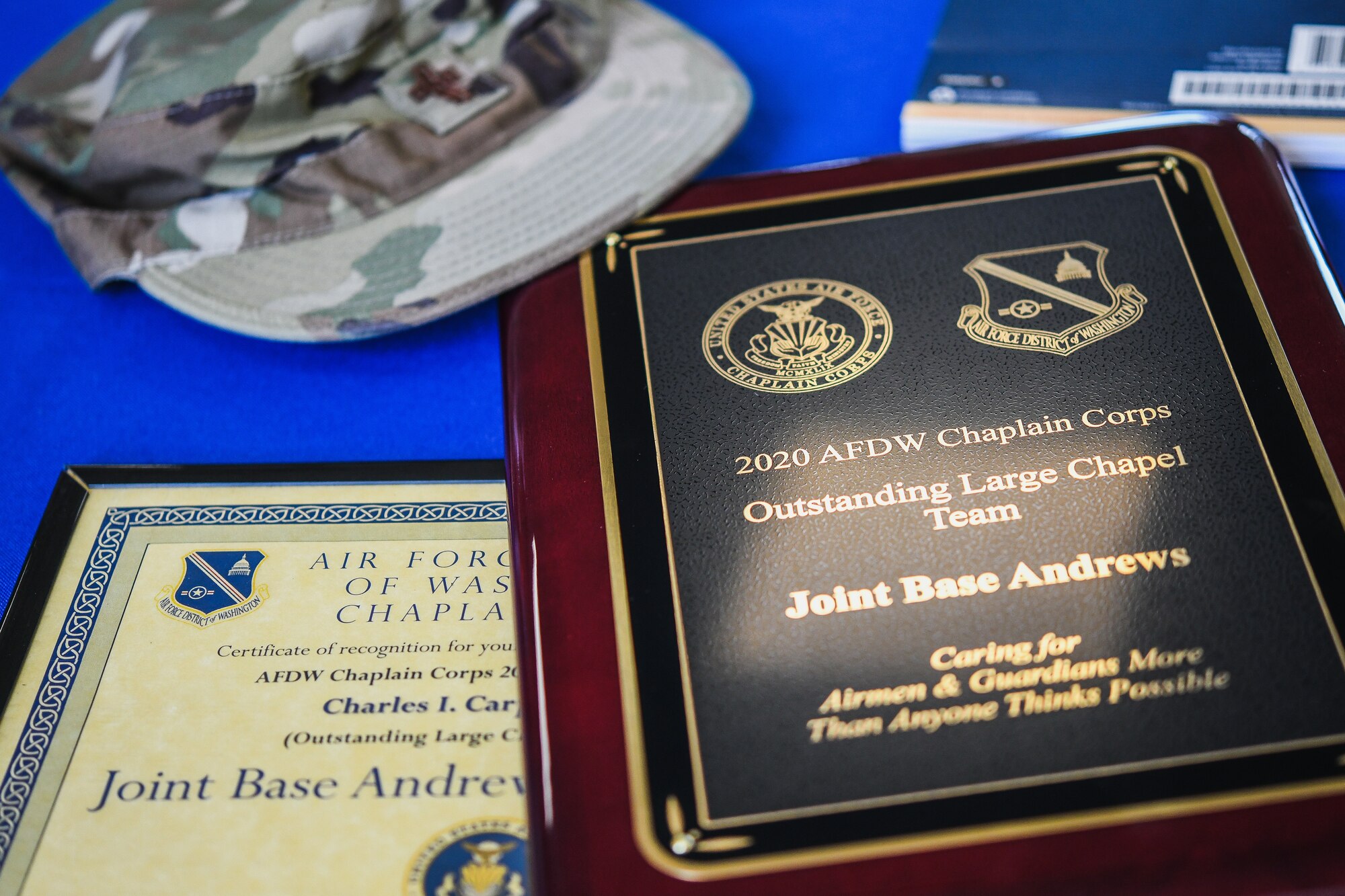 A Charles R. Meier Award and an Outstanding Large Chapel Team Award sit on the table during the 2020 Annual Awards Presentation at Chapel 1, Joint Base Andrews, Md., May 18, 2021. (U.S. Air Force photo by Airman 1st Class Bridgitte Taylor)