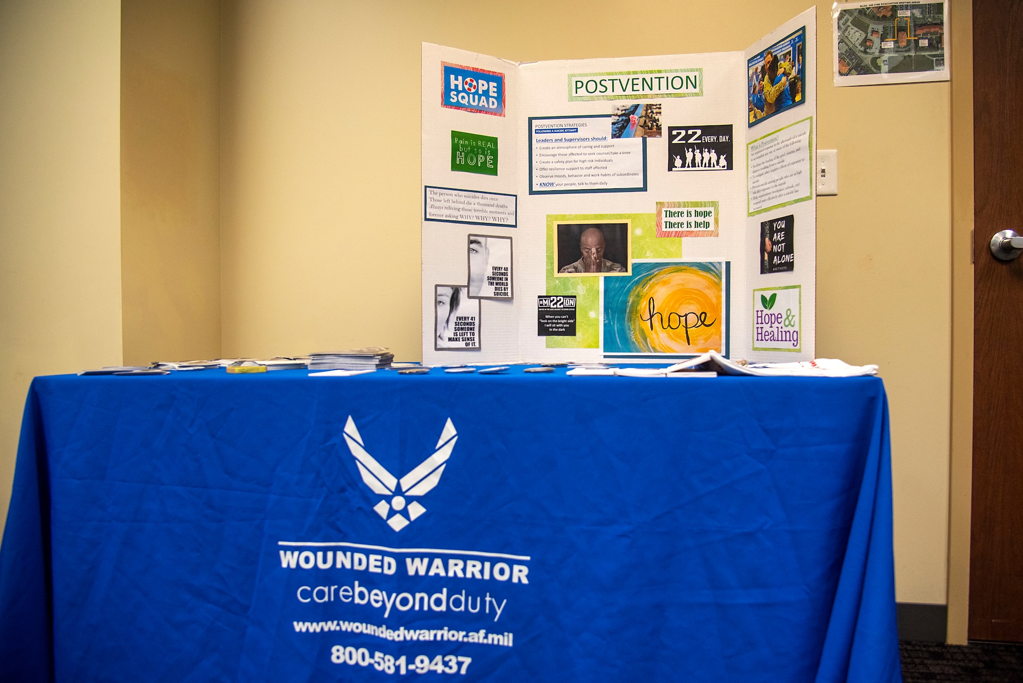 A trifold presentation table is set up with information on suicide intervention during an Applied Suicide Intervention Skills Training (ASIST) course, led by Air Force Wounded Warrior Program (AFW2) leaders, at MacDill Air Force Base, Florida, May 12, 2021. AFW2 is a congressionally-mandated and federally-funded organization tasked with taking care of U.S. Air Force wounded, ill and injured Airmen, Veterans and their families.