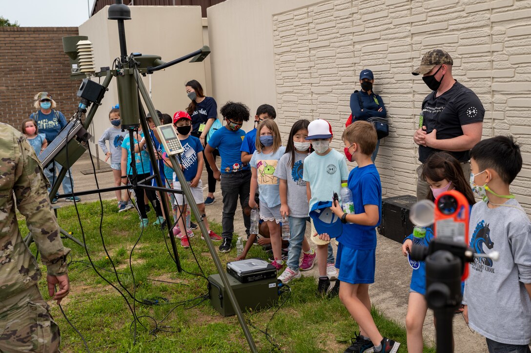 A group of first grade students from Osan Elementary School, learn about weather instruments and equipment at Osan Air Base, Republic of Korea, May 26, 2021. The 51st Operations Support Squadron Weather Flight hosted a field trip to teach students about meteorology and the science of weather. (U.S. Air Force photo by Tech. Sgt. Nicholas Alder)