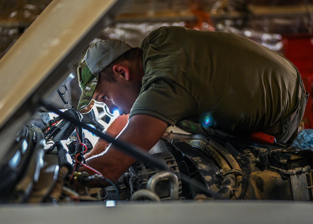 Senior Airman Ryan Knutson, 726th Expeditionary Air Base Squadron vehicle maintenance technician, installs a new part on an ambulance at Chabelley Airfield, Djibouti, May 25, 2021. Knutson has worked on every kind of vehicle at Camp Lemonnier and Chabelley Airfield including, dump trucks, bobtails,    fire trucks, backhoes, and forklifts. (U.S. Air Force photo by Airman 1st Class Jan K. Valle)