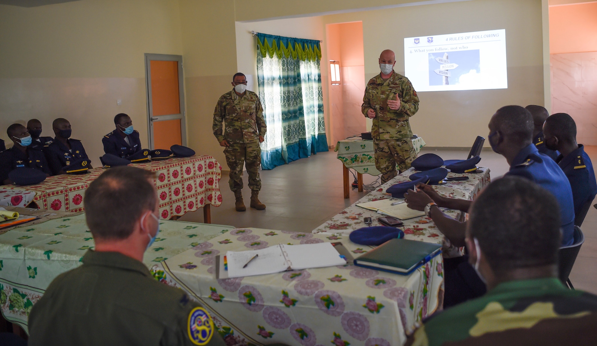 Chief Master Sgt. Terrance Smiley, Kisling Non-commissioned Officer Academy commandant (left), and Brig. Gen. Christopher Ireland, U.S. Air Forces in Europe-Air Forces Africa chief of staff (right), discuss leadership and followership with Senegalese air force members in Thies, Senegal, May 26, 2021. Throughout the engagement, Airmen facilitated several discussions with their Senegalese peers on topics such as leadership, airmanship, administrative processes, doctrine and personnel management. (U.S. Air Force photo by 1st Lt. Hannah Durbin)
